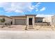 A modern single-story home offers desert landscaping, a brick paver driveway, a two-car garage, and a stone entryway at 5015 Terramont Dr, Las Vegas, NV 89135