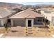 An elevated view of a single-story home with desert landscaping, a brick paver driveway, and a two-car garage at 5015 Terramont Dr, Las Vegas, NV 89135