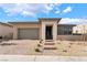 A well-maintained single-story home featuring desert landscaping, a two-car garage, and stone entrance accents at 5015 Terramont Dr, Las Vegas, NV 89135