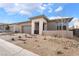 A stylish single-story home features desert landscaping, a brick paver driveway, and a two-car garage at 5015 Terramont Dr, Las Vegas, NV 89135