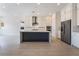 Modern kitchen featuring white cabinets, stainless steel appliances, and a large island at 5015 Terramont Dr, Las Vegas, NV 89135