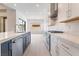 Kitchen with stainless steel appliances, white cabinets, and plenty of counter space at 5015 Terramont Dr, Las Vegas, NV 89135