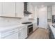 Sleek kitchen with stainless steel appliances, white cabinets, and stone countertops at 5015 Terramont Dr, Las Vegas, NV 89135