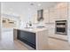 Bright kitchen with a dark blue island, stainless steel appliances, and white countertops at 5015 Terramont Dr, Las Vegas, NV 89135