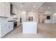 Bright open kitchen featuring an island, white cabinets, and modern appliances at 5015 Terramont Dr, Las Vegas, NV 89135