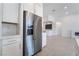 Modern kitchen features stainless steel refrigerator and white cabinets at 5015 Terramont Dr, Las Vegas, NV 89135