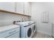 Functional laundry room equipped with a Samsung washer and dryer, plus ample cabinet space at 5015 Terramont Dr, Las Vegas, NV 89135