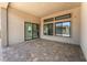 Covered outdoor living patio with tile flooring and modern window and door features at 5015 Terramont Dr, Las Vegas, NV 89135