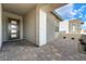 Inviting front porch with brick flooring and a contemporary entryway with a large window at 5015 Terramont Dr, Las Vegas, NV 89135