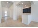 Bright and modern entry area with a wet bar featuring navy cabinets and light tiled floors at 5015 Terramont Dr, Las Vegas, NV 89135