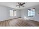 Bedroom featuring a ceiling fan and hardwood floors with windows on two walls at 519 Cayuga Ct, Boulder City, NV 89005