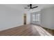 Bright bedroom featuring wood floors, a ceiling fan, and a closet with natural light at 519 Cayuga Ct, Boulder City, NV 89005