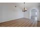 Well-lit dining room showcases a modern chandelier, hardwood floors, and an arched doorway at 519 Cayuga Ct, Boulder City, NV 89005