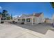 Exterior view of the home with a long, covered patio and decorative landscaping at 519 Cayuga Ct, Boulder City, NV 89005