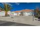 Single-story home featuring a terracotta roof, desert landscaping, and an attached garage at 519 Cayuga Ct, Boulder City, NV 89005