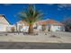 Single-story home featuring a terracotta roof, desert landscaping, and a circular driveway at 519 Cayuga Ct, Boulder City, NV 89005