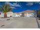 Single-story home featuring a terracotta roof, desert landscaping, and a circular driveway at 519 Cayuga Ct, Boulder City, NV 89005