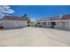 Wide driveway leading to two-car garage, alongside a covered patio and white home exterior at 519 Cayuga Ct, Boulder City, NV 89005