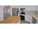 Kitchen featuring stainless steel appliances, white cabinets, and wood countertop island at 519 Cayuga Ct, Boulder City, NV 89005