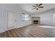 Spacious living room features a stone fireplace and wood-look floors at 519 Cayuga Ct, Boulder City, NV 89005