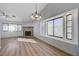 Living room with a fireplace and large windows for ample natural light at 519 Cayuga Ct, Boulder City, NV 89005