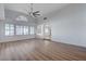 Spacious living room with hardwood floors, arched doorway, and many windows for natural light at 519 Cayuga Ct, Boulder City, NV 89005