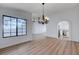 Hardwood floors accent this cozy living area with a large window and arched doorway at 519 Cayuga Ct, Boulder City, NV 89005