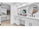 Modern bathroom featuring double sinks, sleek black faucets, and a spacious walk-in closet at 5264 Silverheart Ave, Las Vegas, NV 89142