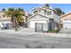 Two-story home with gray stucco, tile roof, black wrought iron gate, and palm trees at 5264 Silverheart Ave, Las Vegas, NV 89142