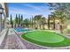 Beautiful backyard featuring a pool, putting green, and elegant landscaping at 5434 Pendini Point Ct, Las Vegas, NV 89141