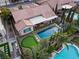 Aerial view of a backyard with a pristine pool, putting green, outdoor kitchen and patio for relaxation and entertainment at 5434 Pendini Point Ct, Las Vegas, NV 89141