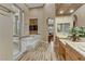 A bathroom with a large vanity and a walk in glass shower with marble surround at 5434 Pendini Point Ct, Las Vegas, NV 89141