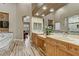 Bathroom with double vanity, wood look floors, a soaking tub and walk-in shower at 5434 Pendini Point Ct, Las Vegas, NV 89141