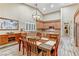 Dining area into kitchen with island, custom cabinets, and hardwood floors at 5434 Pendini Point Ct, Las Vegas, NV 89141