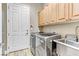 Modern laundry room equipped with new washer, dryer, sink, and storage cabinets at 5434 Pendini Point Ct, Las Vegas, NV 89141