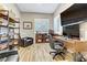 Home office setup with a large desk, comfortable chair, and plenty of natural light at 5434 Pendini Point Ct, Las Vegas, NV 89141