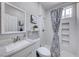 Clean bathroom with modern vanity and framed mirror, features shower with decorative inset at 5507 Nickel Ridge Way, Las Vegas, NV 89122