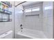 Bright, tiled bathroom featuring a standard tub with shower and a decorative inset at 5507 Nickel Ridge Way, Las Vegas, NV 89122