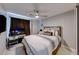 Comfortable bedroom featuring a ceiling fan, desk, and mounted TV for relaxation and convenience at 5507 Nickel Ridge Way, Las Vegas, NV 89122