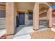 Close up of a well-maintained home exterior with welcoming front door and covered porch at 5507 Nickel Ridge Way, Las Vegas, NV 89122