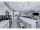 Spacious eat-in kitchen featuring stainless steel appliances, gray backsplash and kitchen island at 5507 Nickel Ridge Way, Las Vegas, NV 89122