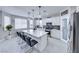 Bright kitchen featuring white cabinetry, a marble island with seating, and stainless steel appliances at 5507 Nickel Ridge Way, Las Vegas, NV 89122