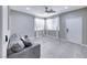 Bright living room with modern gray color scheme, tile flooring, and natural light at 5507 Nickel Ridge Way, Las Vegas, NV 89122