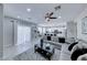 Open floor plan showcases a living room flowing into a well-lit kitchen with a large sectional sofa at 5507 Nickel Ridge Way, Las Vegas, NV 89122