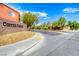 Community entrance with attractive signage, landscaping, and well-maintained street view at 5507 Nickel Ridge Way, Las Vegas, NV 89122