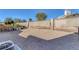 Low maintenance backyard featuring gravel, mature landscaping, perimeter fencing and home exterior at 5732 Colwood Ln, Las Vegas, NV 89130