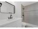 Modern bathroom featuring vanity with quartz countertop and tiled shower at 5732 Colwood Ln, Las Vegas, NV 89130