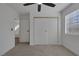 Carpeted bedroom featuring a closet with sliding doors and a window for natural light at 5732 Colwood Ln, Las Vegas, NV 89130