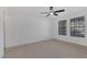 A spacious bedroom featuring modern windows, a ceiling fan and neutral carpeting at 5732 Colwood Ln, Las Vegas, NV 89130