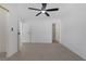 A spacious bedroom featuring neutral carpeting, and a ceiling fan at 5732 Colwood Ln, Las Vegas, NV 89130